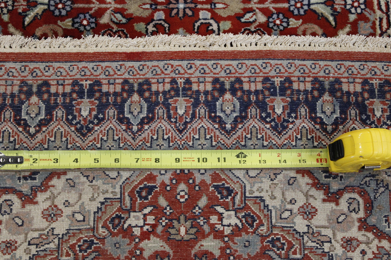 Red Traditional Fine Tabriz rug in room setting