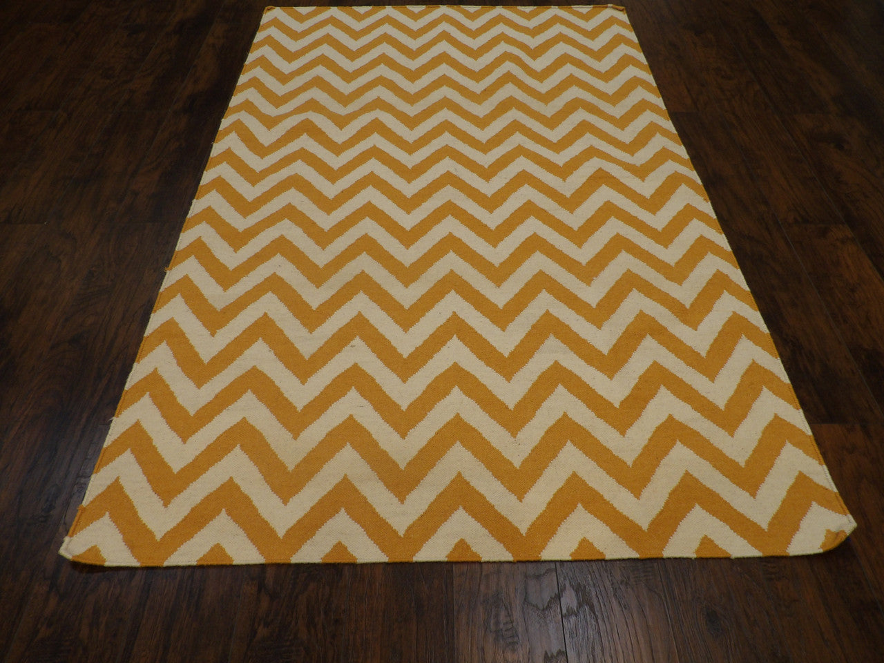 Close-up of flatweave texture, gold coastal rug