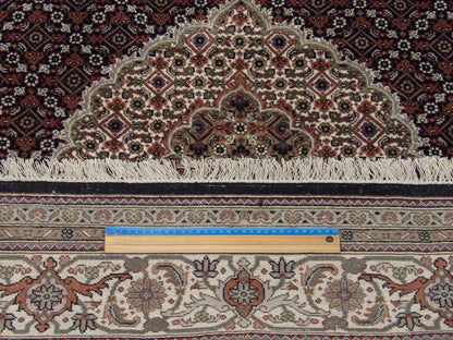 Black & Beige Fine Persian Mahi Tabriz rug in room setting