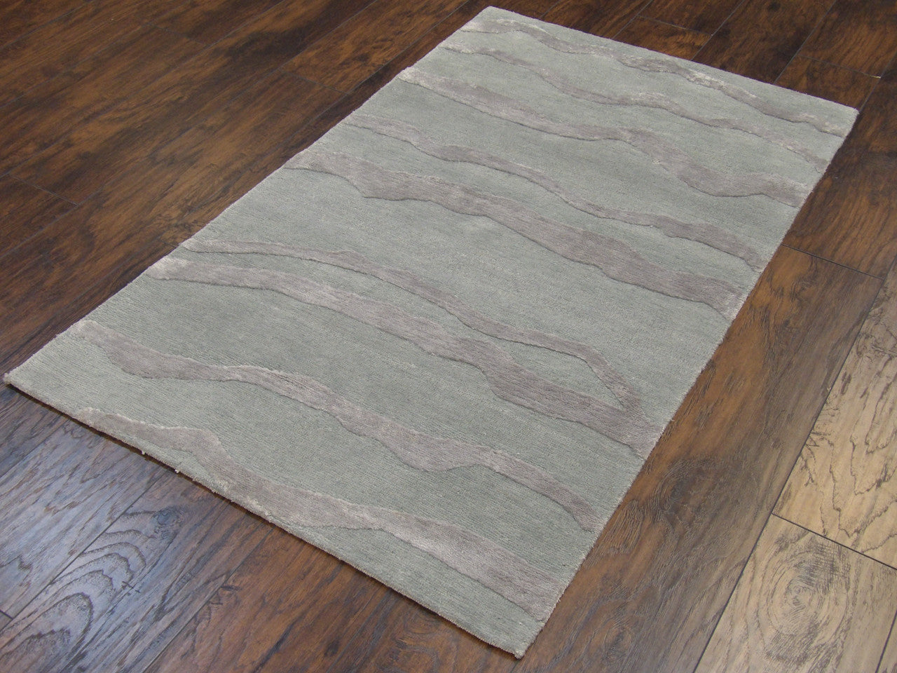 Wave pattern detail, green rug