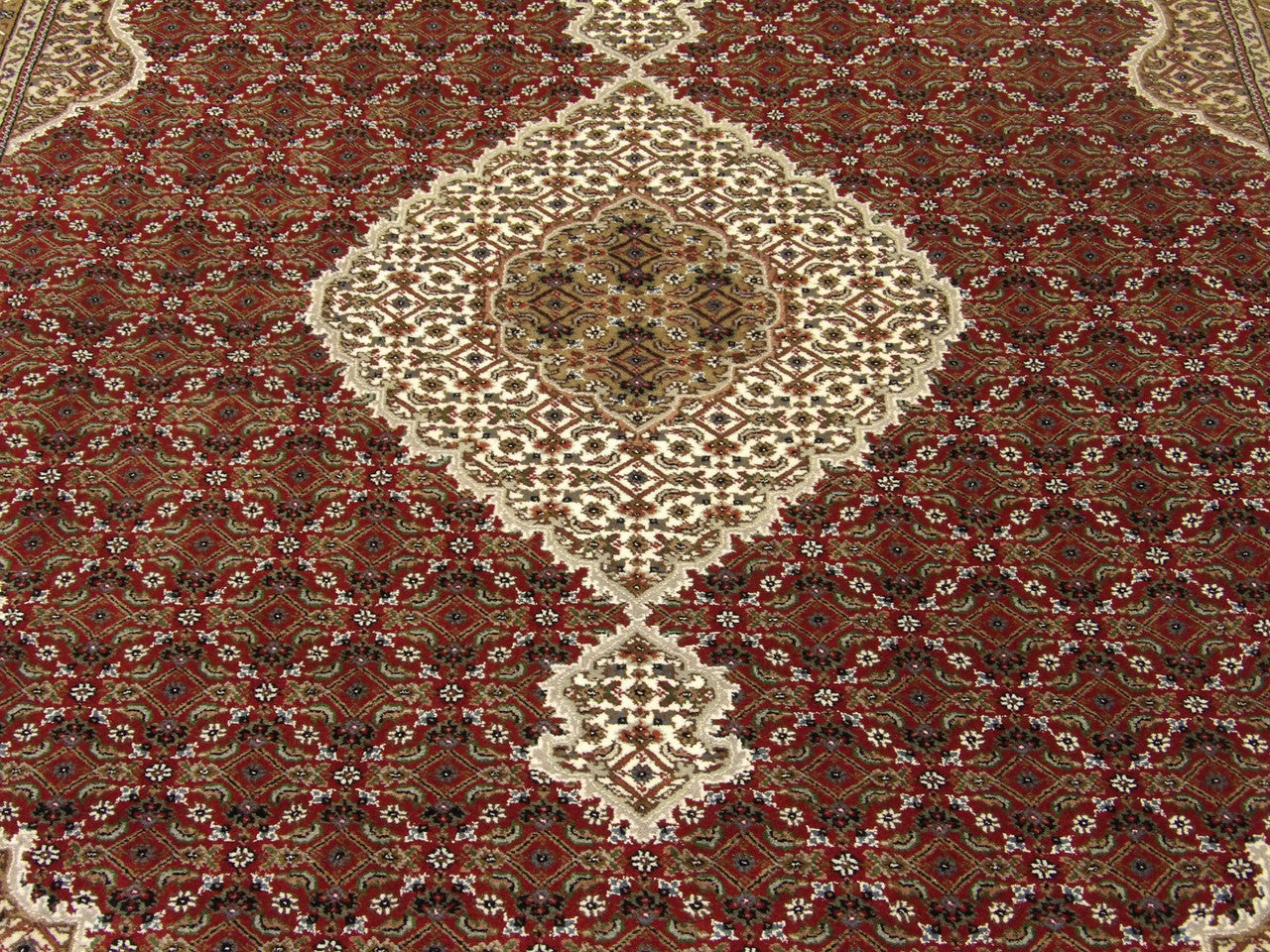 Wool-silk texture close-up, red and ivory Tabriz rug
