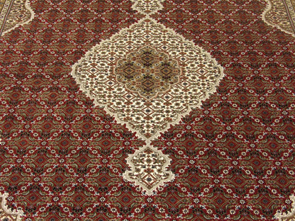 Wool-silk texture close-up, red and ivory Tabriz rug