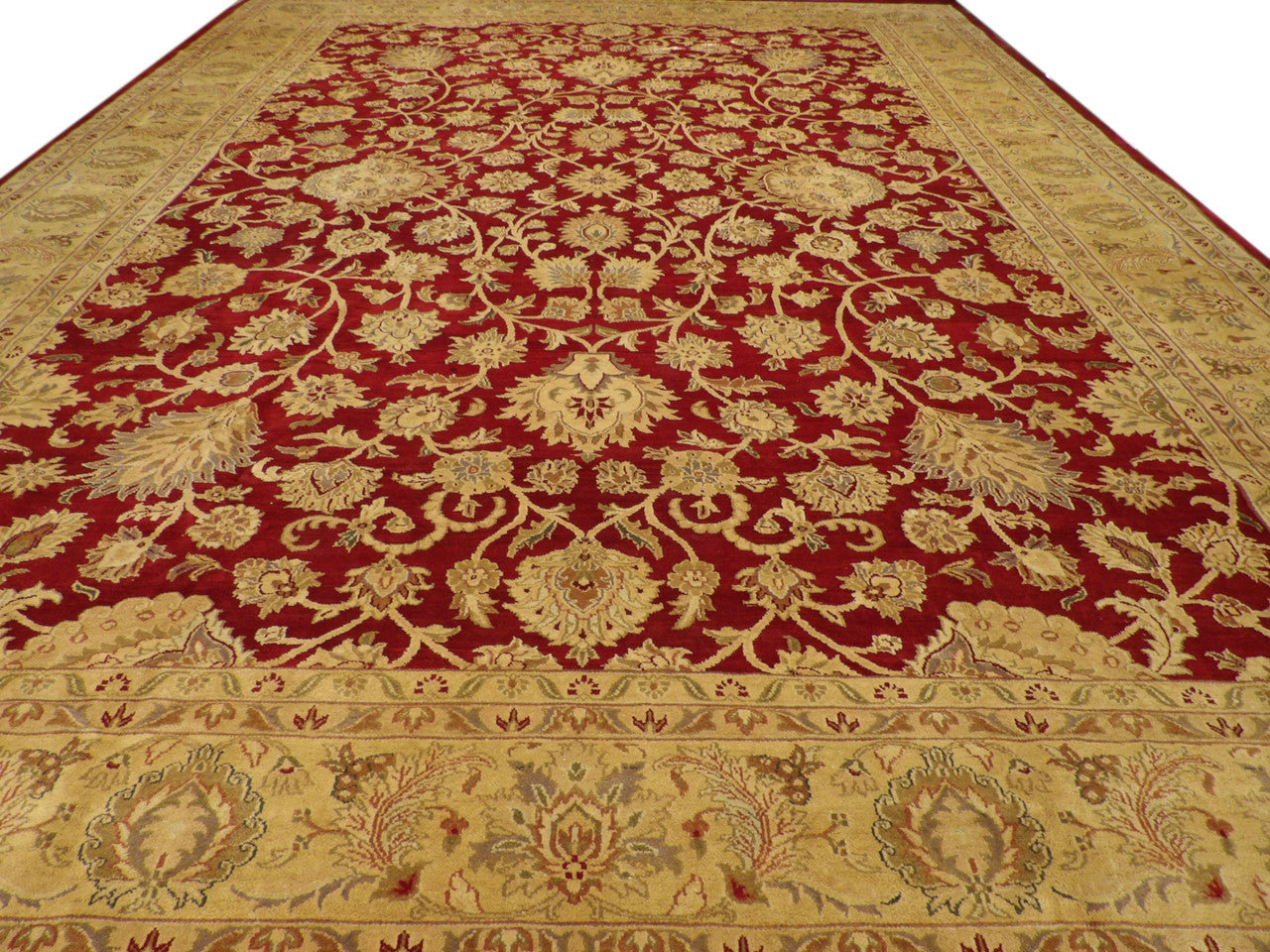 Close-up of wool pile, gold and red rug