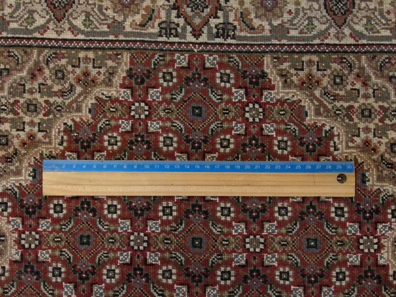 Beige & Red Fine Persian Tabriz rug in room setting