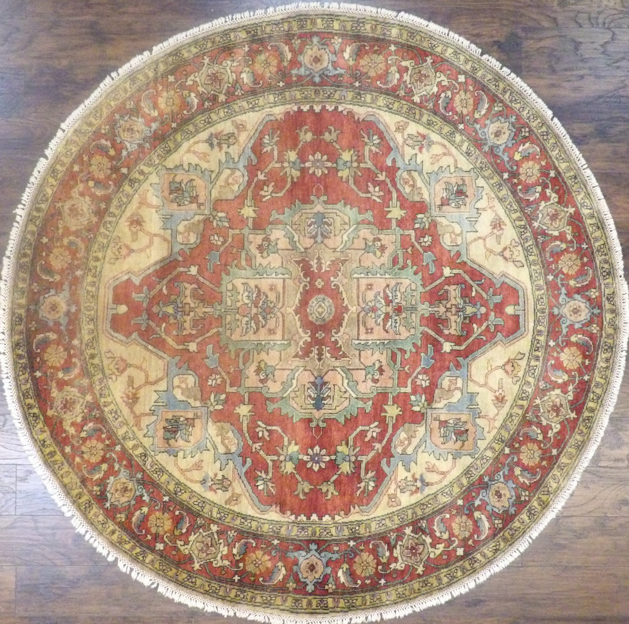 Tribal Sherapi hand-knotted wool rug in gold and rust, round, full view