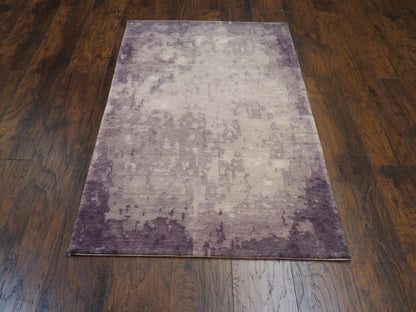 Close-up of wool-silk pile, gray and purple rug
