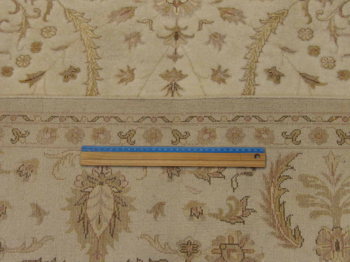 Beige Fine Persian Haji Jalili rug in room setting