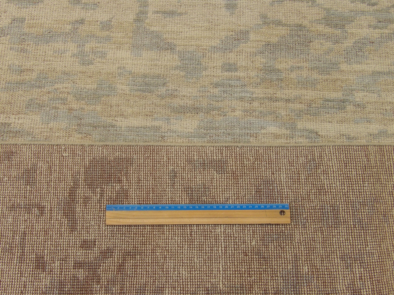 Blue and gold Oushak rug in room setting