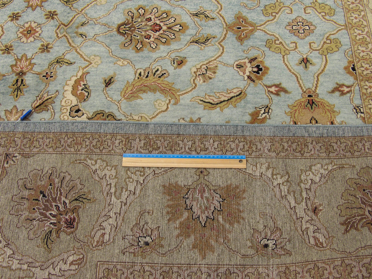 Blue and gold Kashan rug in room setting