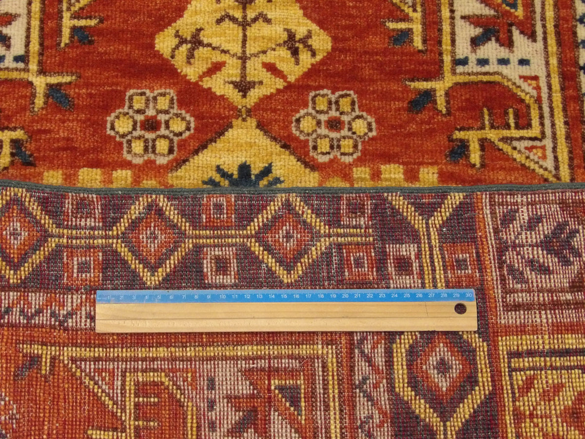 Green & Rust Tribal Turk Heraki rug in room setting