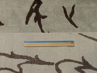 Blue and brown leaves rug in room setting