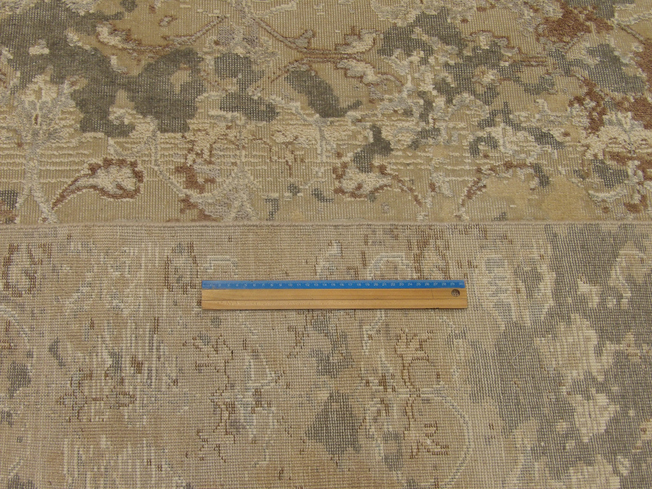 Vintage green and beige rug in room setting
