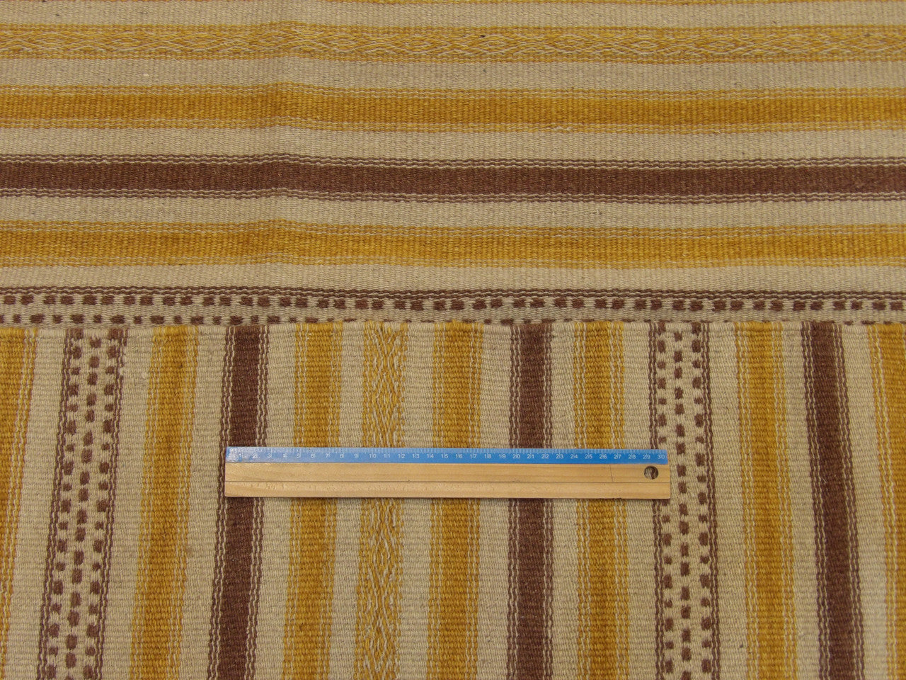 Brown and gold coastal rug in room setting