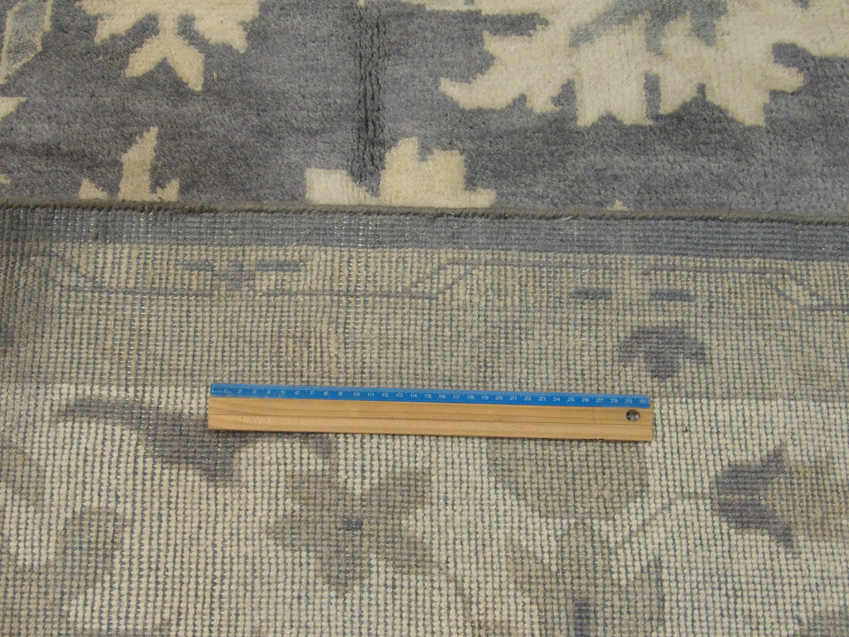 Gray and beige Oushak rug in room setting