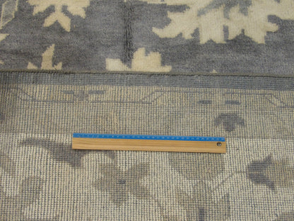 Gray and beige Oushak rug in room setting