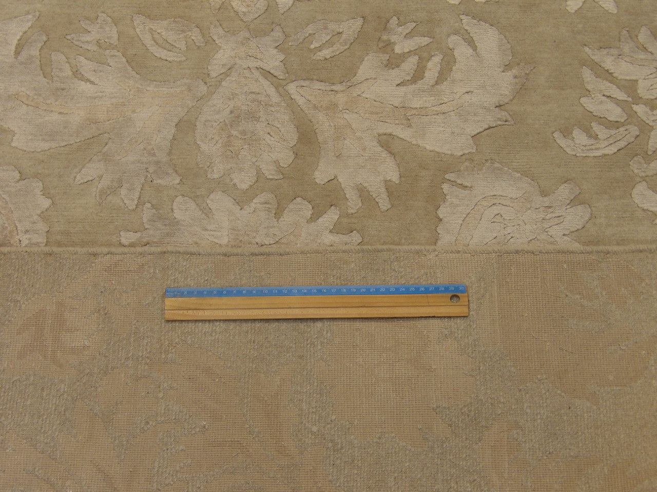 Beige floral rug in room setting