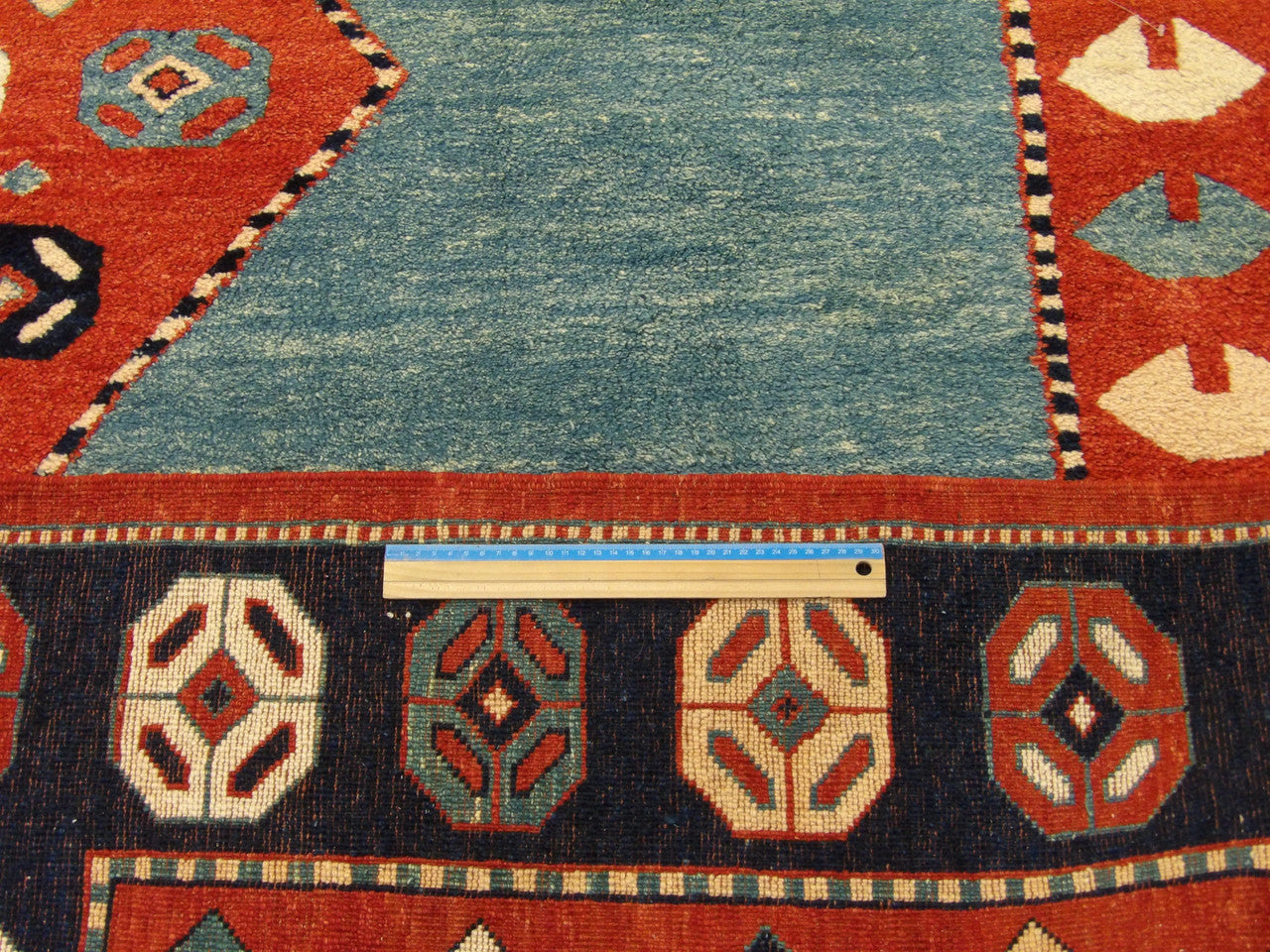 Green, Teal & Blue Turkish Tribal Antique Khorjan rug in room setting