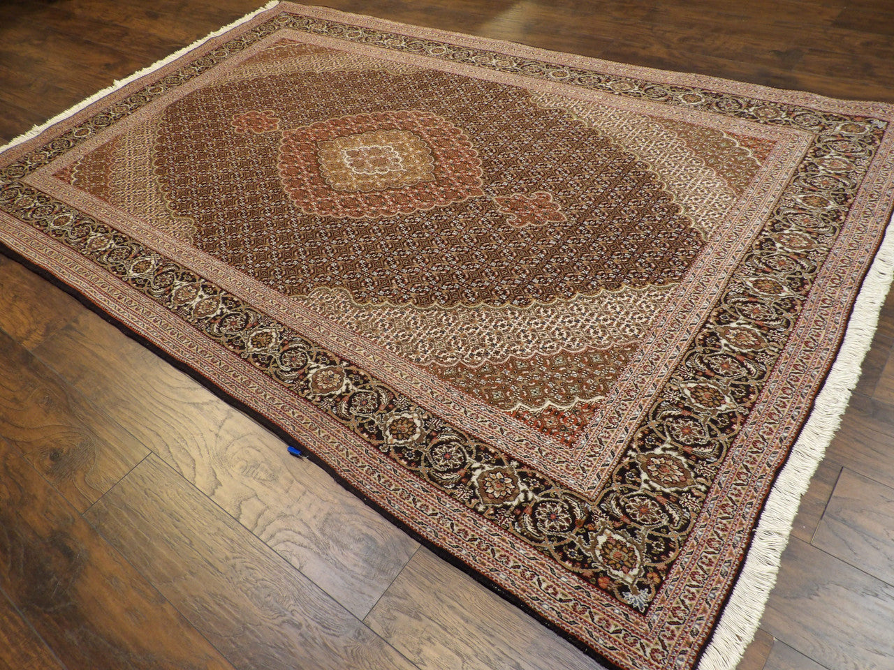 Mahi fish motif pattern detail, black wool-silk Tabriz rug