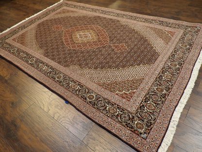 Mahi fish motif pattern detail, black wool-silk Tabriz rug