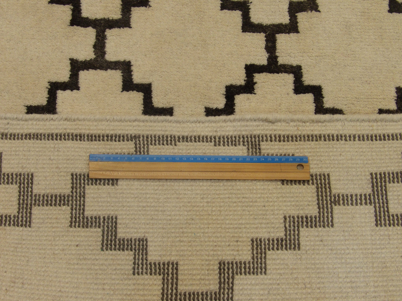 Gray and ivory Moroccan diamond rug in room setting