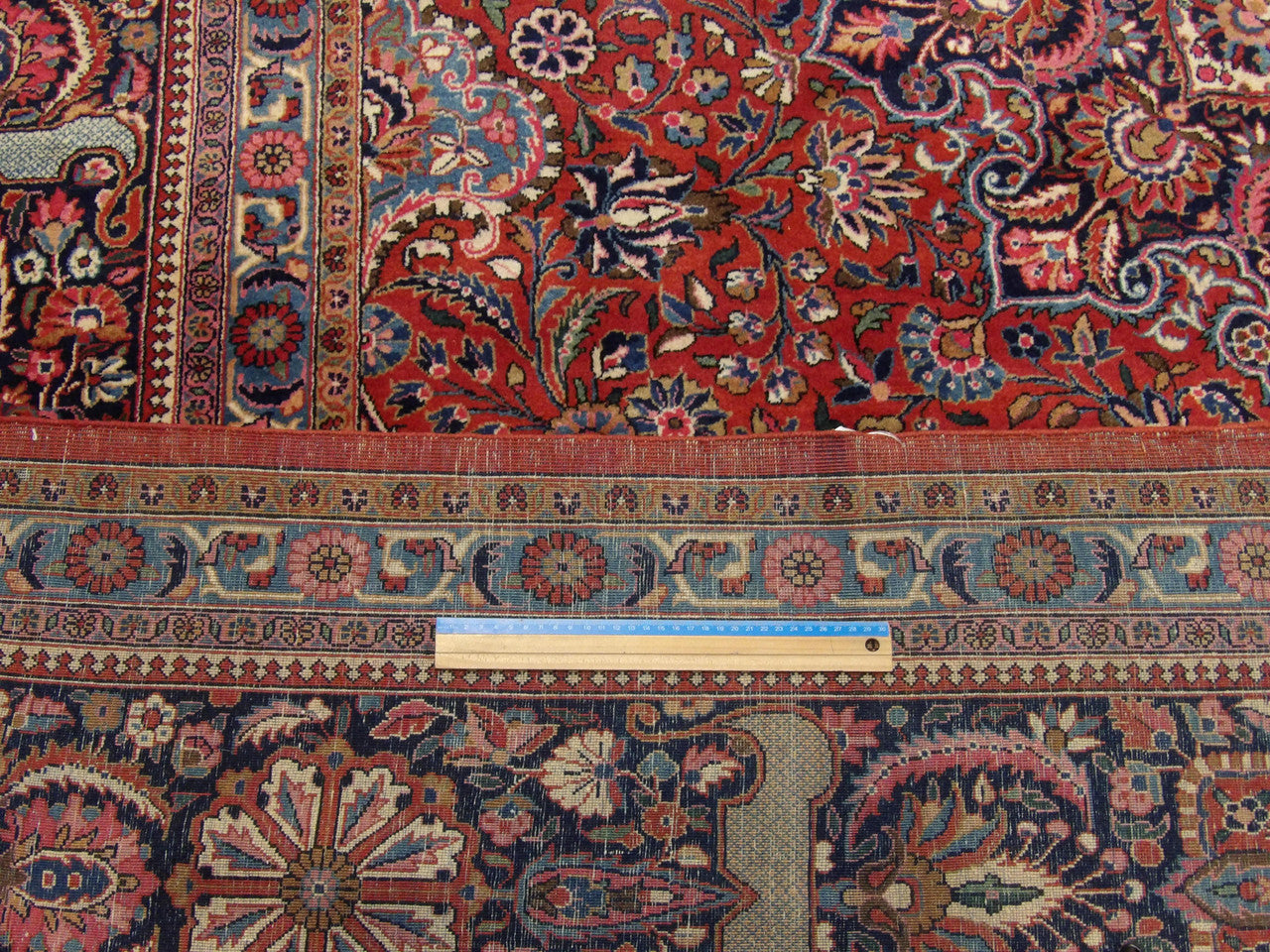 Blue and red antique Tabriz rug in room setting