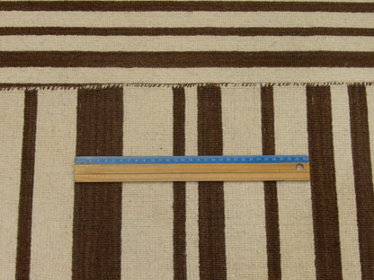 Brown and beige coastal rug in room setting