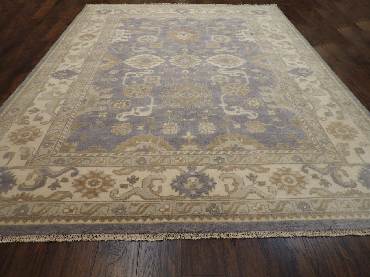 Ivory and purple Oushak rug in a living room setting