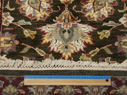 Green and red Kashan runner in hallway setting