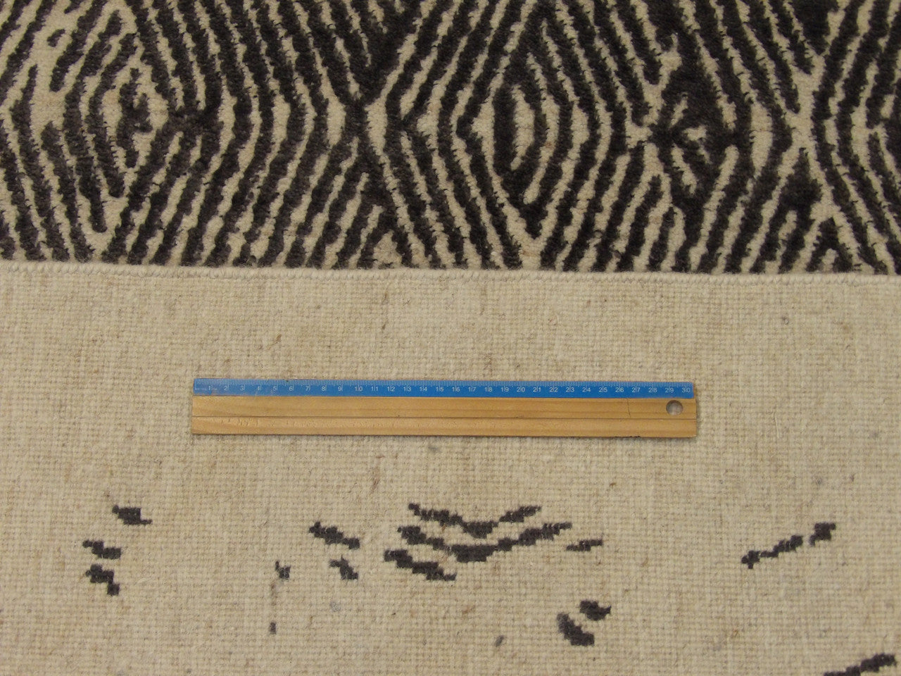 Black & Beige Modern Broken Net Design rug in room setting