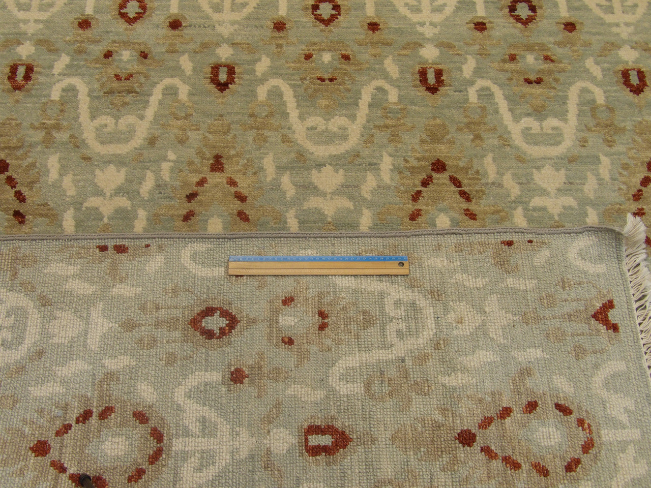 Blue and red Oushak rug in room setting