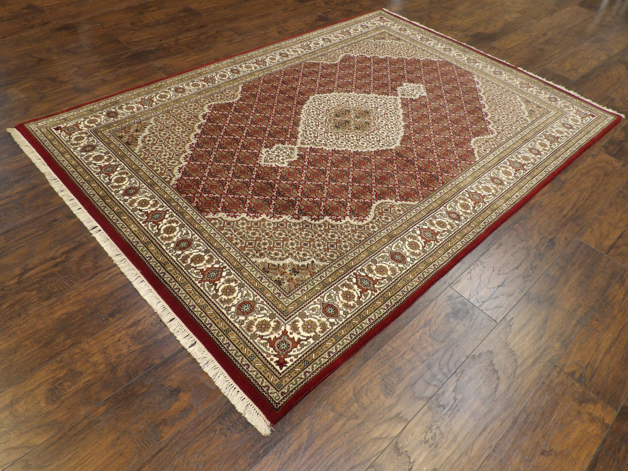 Mahi fish medallion pattern detail, red and ivory rug