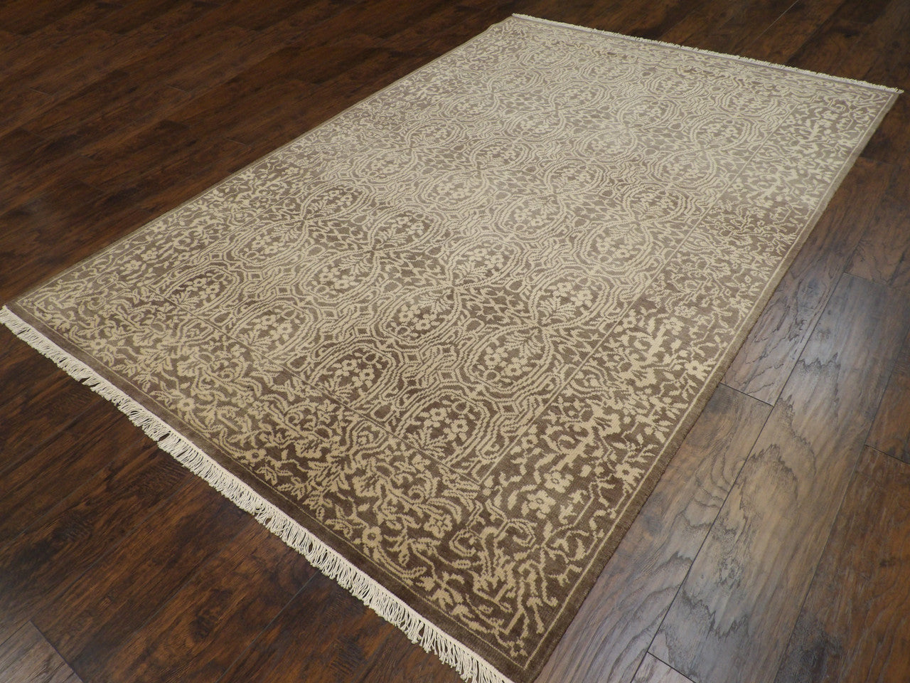 Damask pattern detail on brown and gold hand-knotted rug