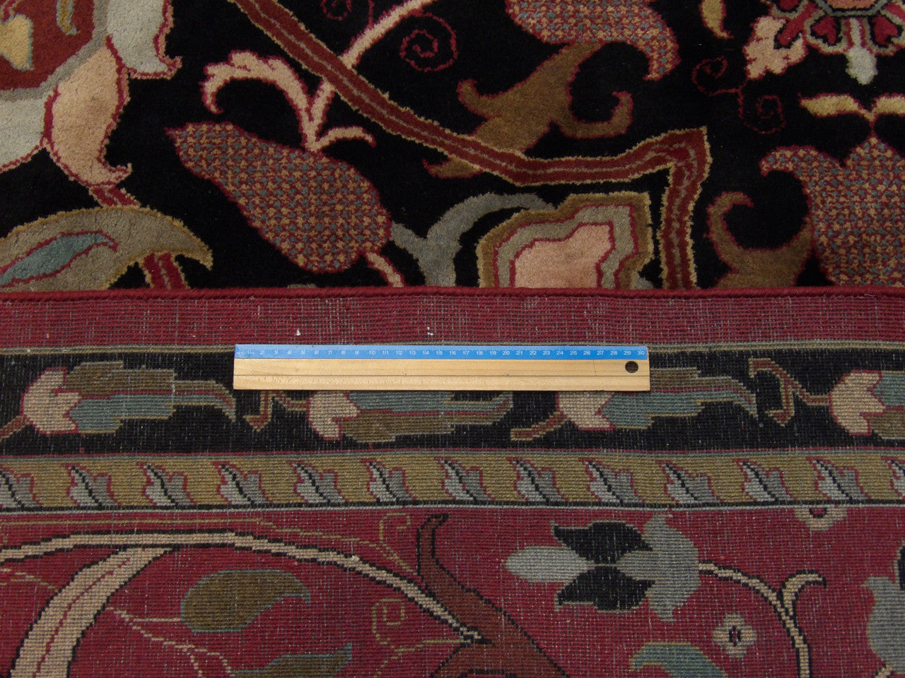 Black & Red Tibetan Mashad Design rug in room setting