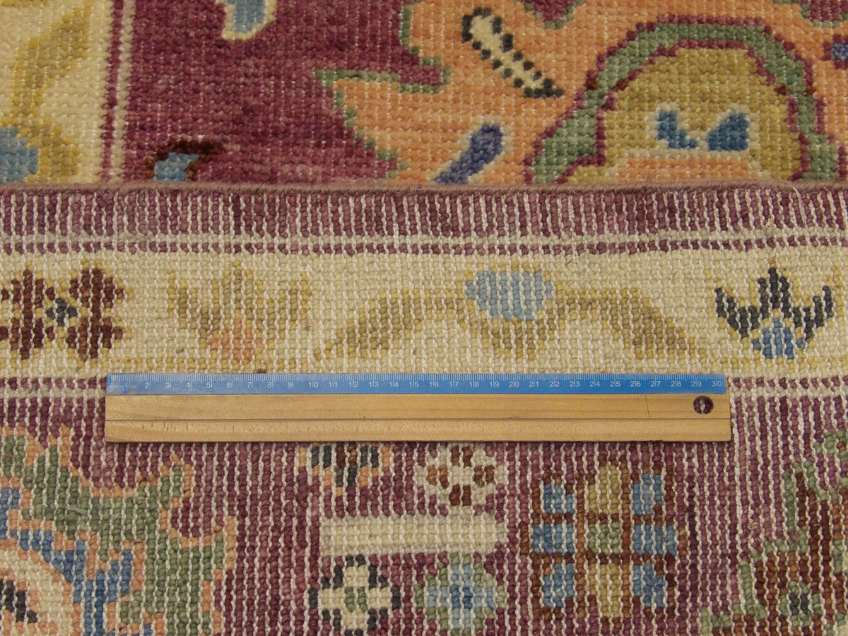 Purple Oushak rug in room setting