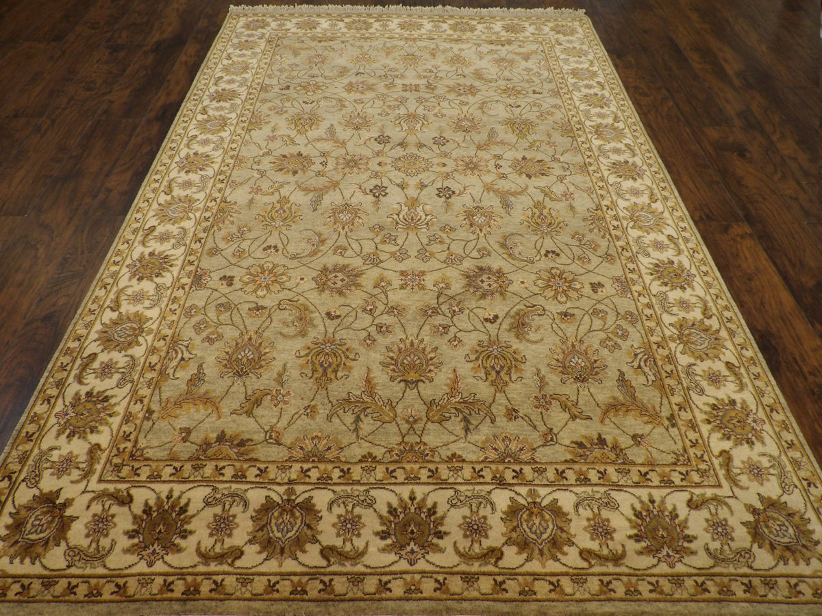 Close-up of wool pile, green and ivory rug