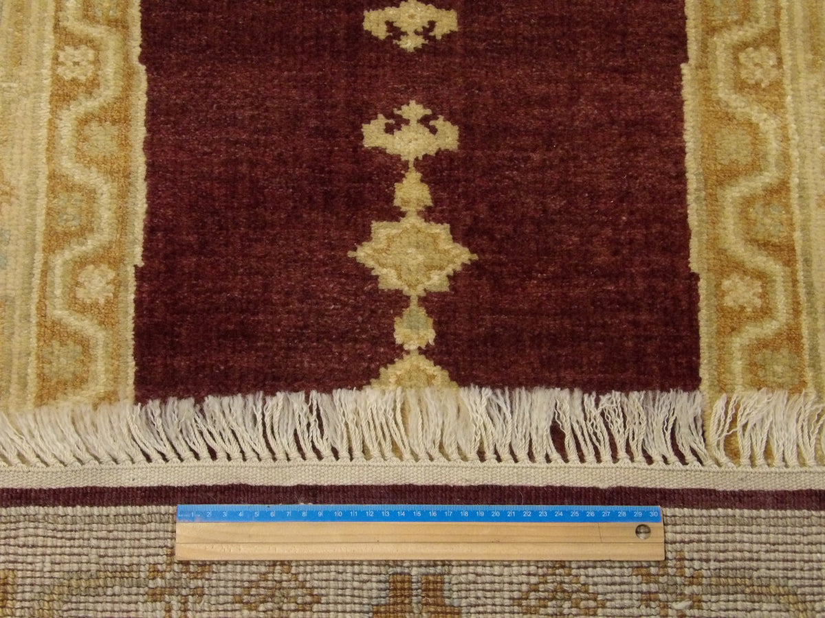 Brown and gold Oushak runner in hallway setting