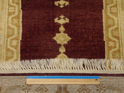 Brown and gold Oushak runner in hallway setting