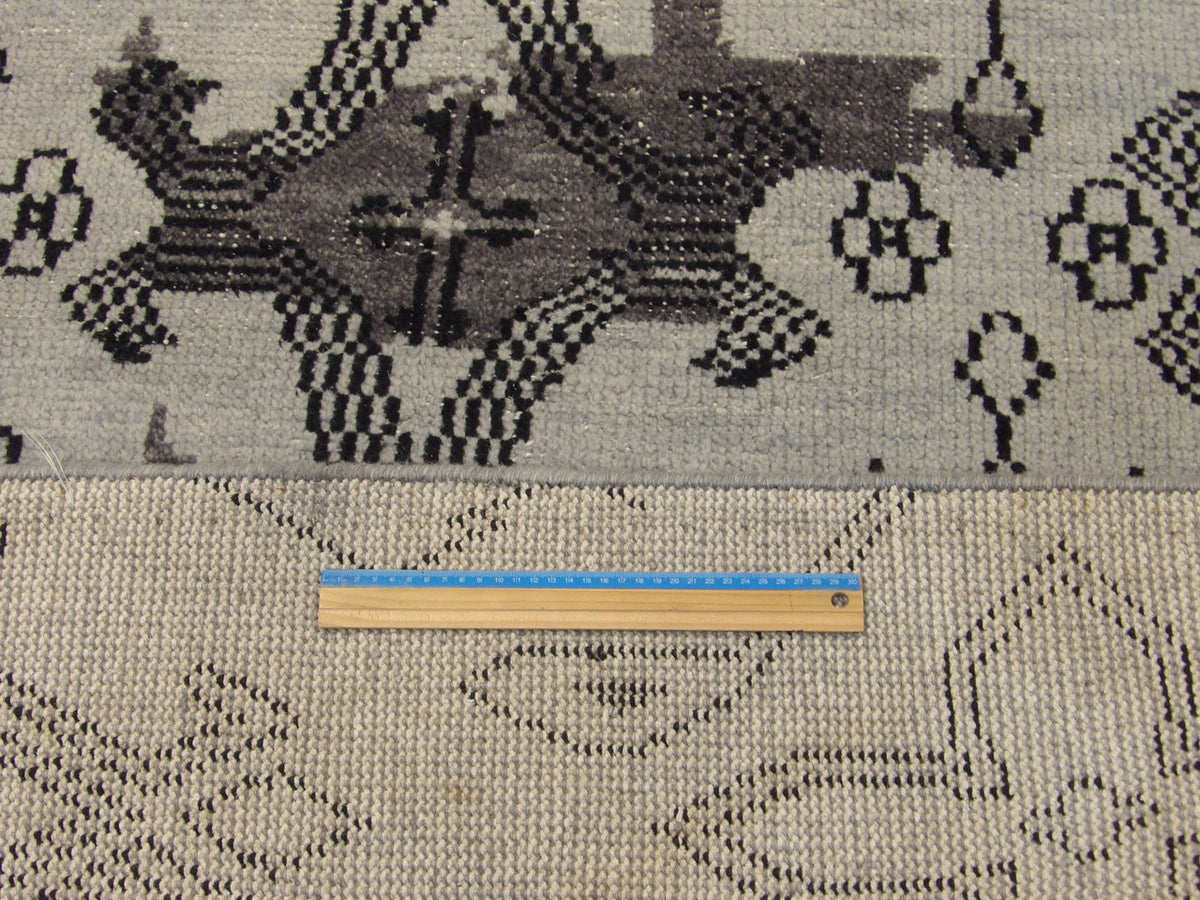 Black and blue Oushak rug in room setting