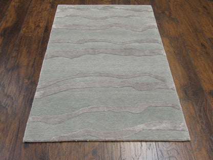Close-up of wool-silk pile, green and gray rug