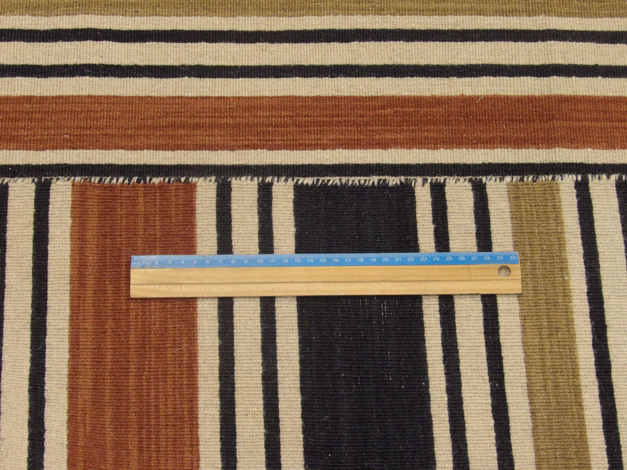 Black and brown coastal rug in room setting