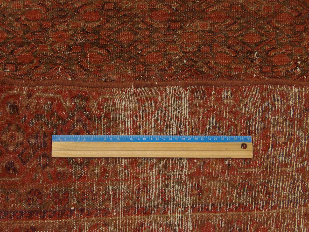 Red Antique Vintage Worn Out Mir Herati rug in room setting