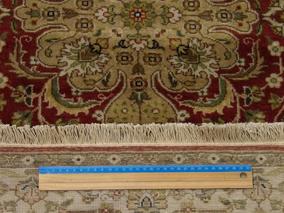 Beige & Red Fine Persian Tabriz rug in room setting