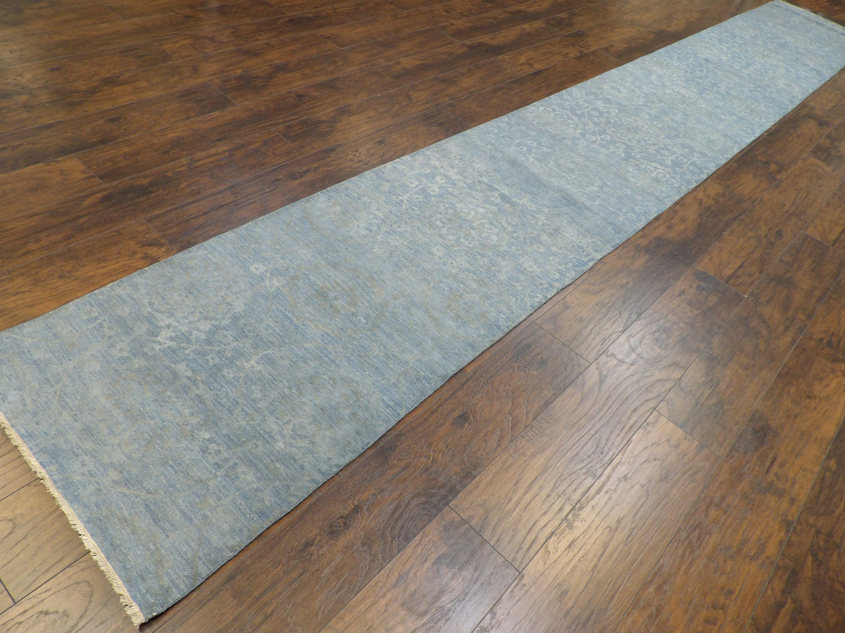 Blue stone wash runner in a long hallway setting