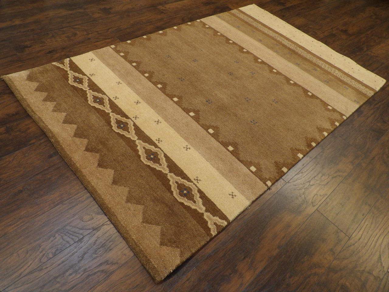 Gabbeh pattern detail, beige and brown natural dye rug