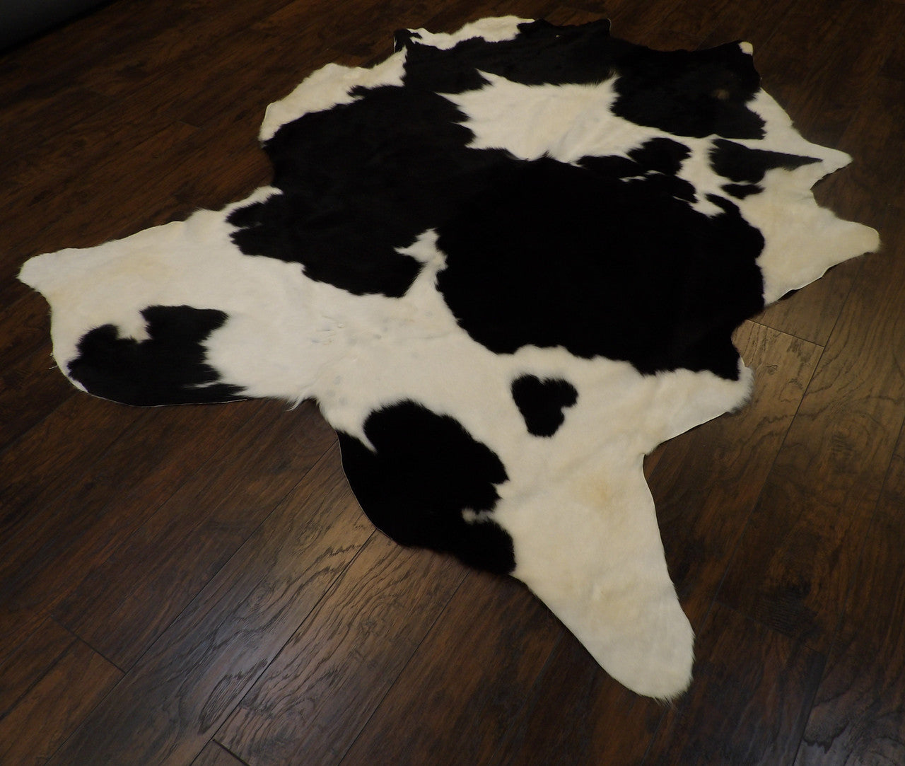 Black and white cowhide rug in a room setting