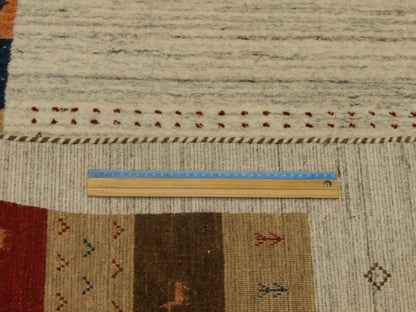 Beige and red Gabbeh rug in room setting
