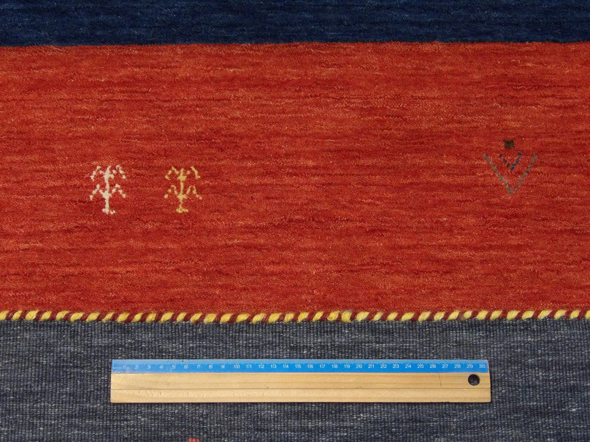 Multi-Color, Red & Blue Modern Gabbeh rug in room setting