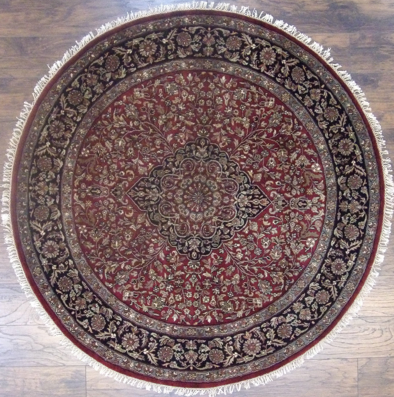 Fine Persian Tabriz hand-knotted wool round rug in black and red, full view