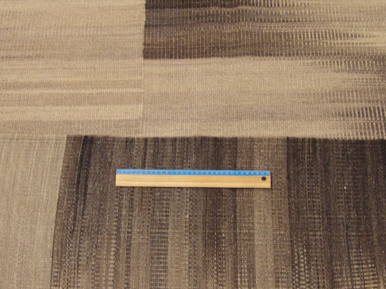 Black and beige coastal rug in room setting