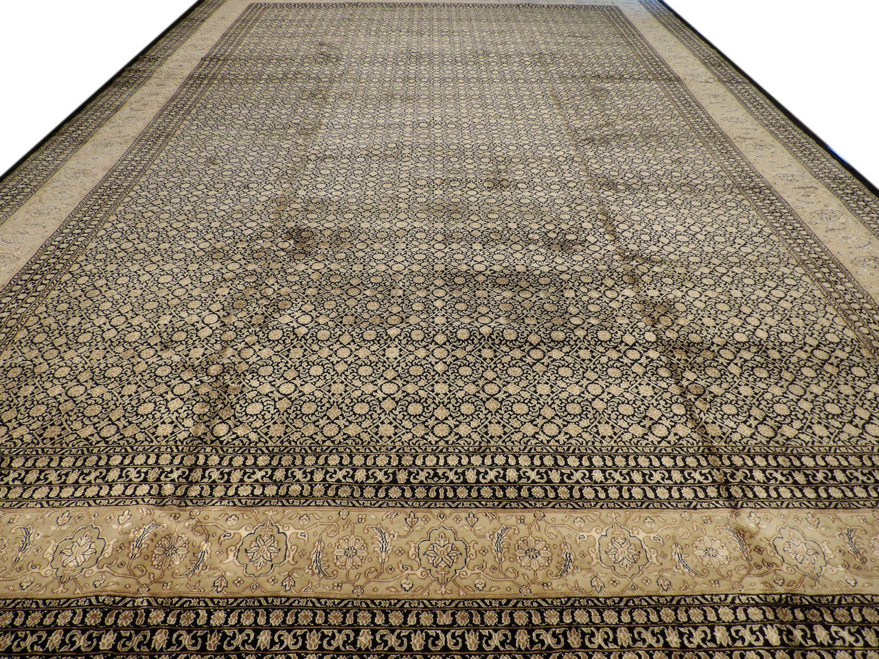 Close-up of wool-silk pile, black and beige rug